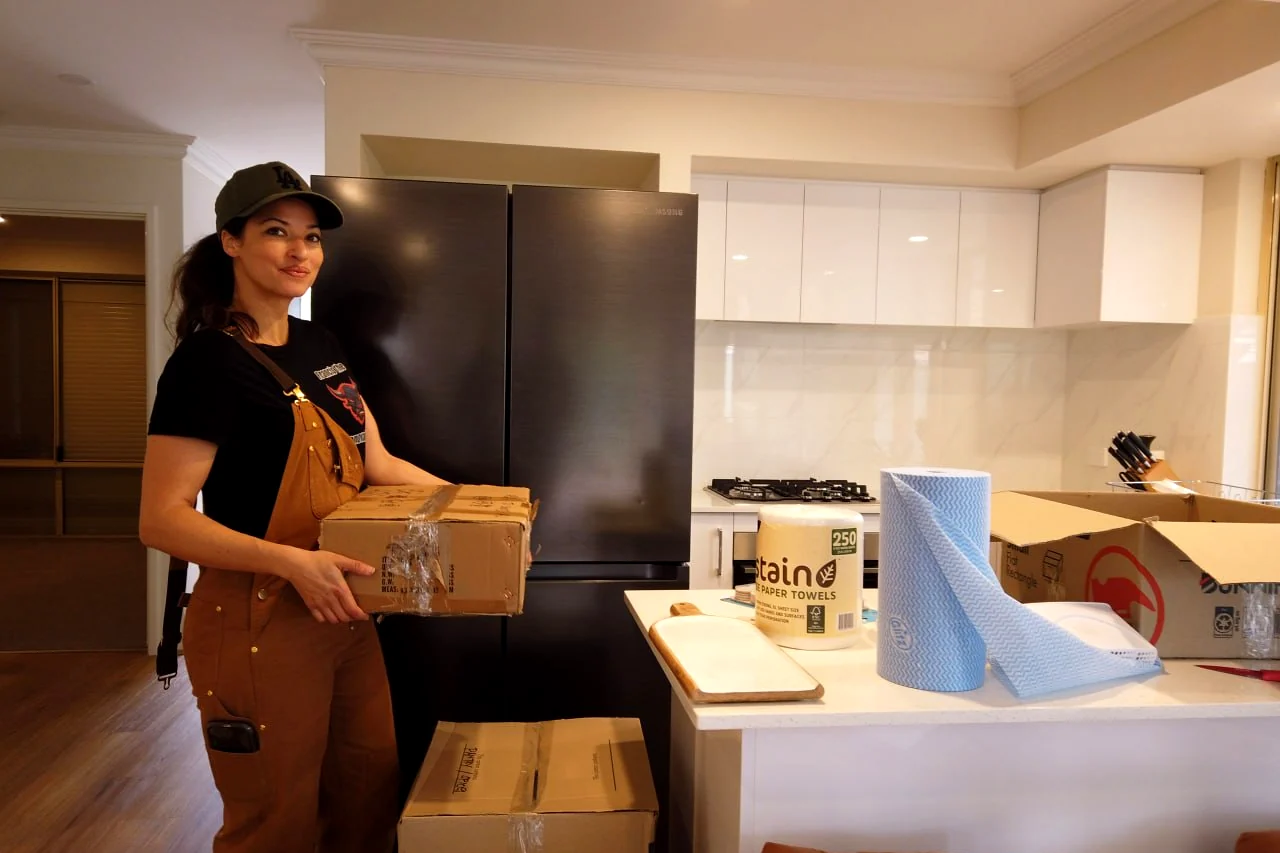 Furniture Removalists Perth packer carrying a packed carton in a Perth kitchen