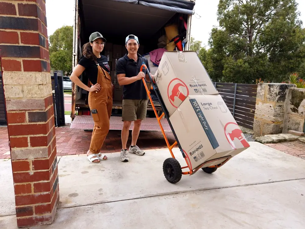 Furniture Removalists Perth crew wheeling packed cartons to the truck on a trolley