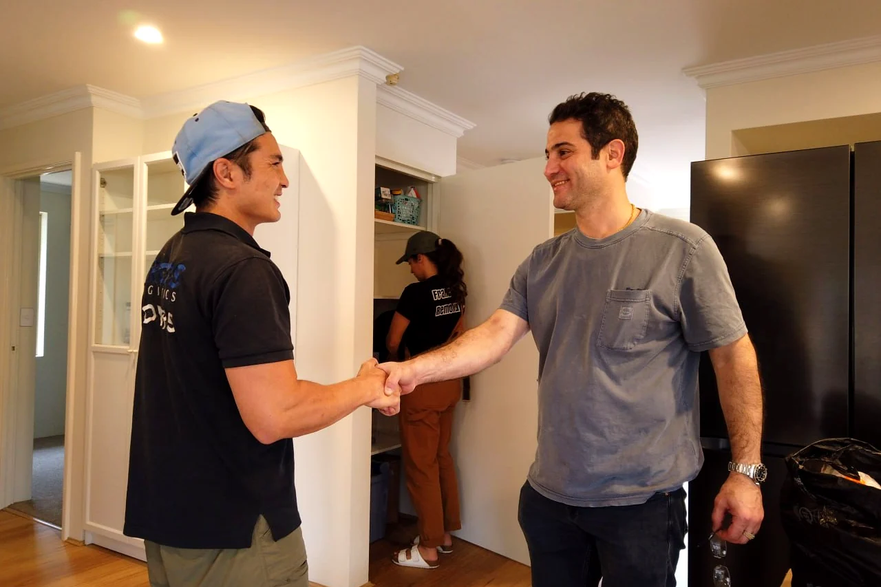 Perth removalist shaking hands with a customer in their kitchen after the white goods were moved